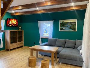 a living room with a couch and a table at Sielankowe Pole in Józefów