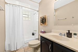a white bathroom with a toilet and a sink at Cozy 3BR Home Friendly City of Hazel Park in Hazel Park +13 photos