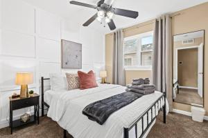 a bedroom with a bed and a ceiling fan at Cozy 3BR Home Friendly City of Hazel Park in Hazel Park