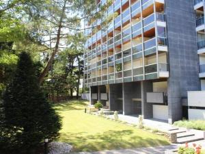 an apartment building with a lawn in front of it at T1 bis neuf avec petite chambre à 150m de la plage in La Baule