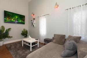 a living room with a couch and a table at Jacksonville Newly Renovated Stylish 3BR Downtown in Jacksonville