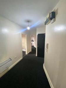 a room with a hallway with a blue light at Cosy living in Camberley