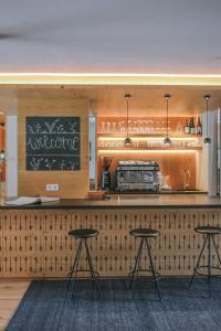 a bar with two tables and a chalkboard at OVINA`s HAUS in Sand in Taufers