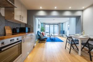 a kitchen and dining room with a table and chairs at 1 bed pontcanna getaway in Cardiff