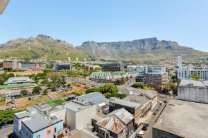 an aerial view of a city with mountains in the background at Neighbourgood 84 Harrington in Cape Town