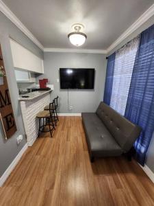 a living room with a couch and a bar at Blue Shark *E10* @ Midtown Vibrant King Studio in Houston