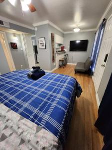 a bedroom with a blue bed and a living room at Blue Shark *E10* @ Midtown Vibrant King Studio in Houston