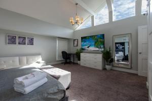 a bedroom with a bed and a tv in it at Jacksonville Newly Renovated Stylish 3BR Downtown in Jacksonville