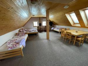 Cette chambre comprend plusieurs lits, une table et des chaises. dans l'établissement Chata Boubín, à Kubova Huť