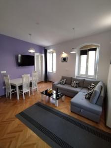 a living room with a couch and a table at Garden Apartment in Split