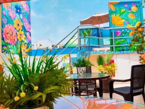 a balcony with a table and chairs and a mural at Casa Fanning Hotel in Lima