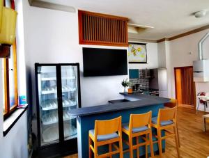 a kitchen with a blue counter and some chairs at ehemalige Kirche in neuem Glanz in Oranienbaum-Wörlitz