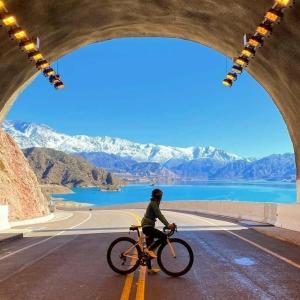 a person riding a bike on a road at Alon Ayun Centro Dpto 1 in Mendoza