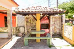 a patio with a gazebo and a grill at Excelente casa c lazer prox a praia Tamandare PE in Tamandaré