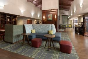 a living room with a couch and two tables at Hampton Inn & Suites Scottsburg in Scottsburg