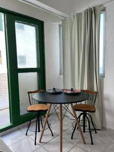a table and chairs in a room with a window at Apartamento a beira-mar Natal in Natal +17 photos