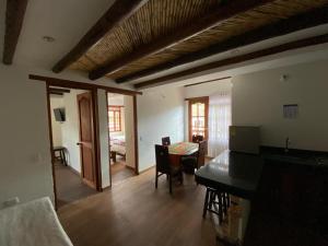 a living room with a table and a dining room at Muisca Hotel Villa de Leyva in Villa de Leyva