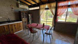 a kitchen with a table and chairs in a room at Rincón "MIS SOLES" in Maipú
