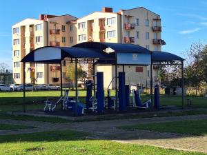 a bus stop with swings and a pavilion in a park at Next Level in Poti