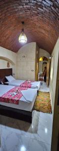 a bedroom with three beds in a large room at Queen House in Aswan