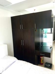 una camera con letto e armadio nero di Studio Unit Persimmon Condominium a Cebu City