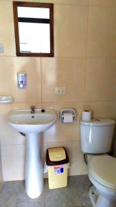 a bathroom with a sink and a toilet at Casa Samay Mountain View in Ollantaytambo