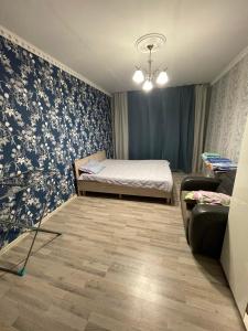 A bed or beds in a room at House near airport ЖК ЮГ
