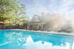 a house with a swimming pool in front of a house at Cape Arundel Inn - Club House in Kennebunkport