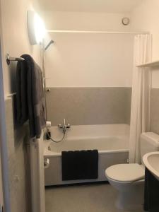 a bathroom with a tub and a toilet and a sink at Bellevue- Bellavista in Castagnola