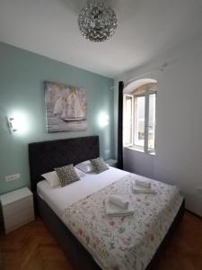 a bedroom with a bed and a chandelier at Garden Apartment in Split
