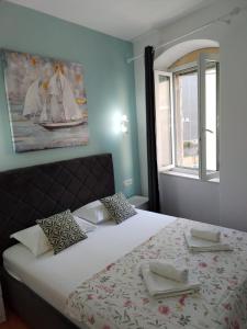 a bedroom with a large bed with a window at Garden Apartment in Split