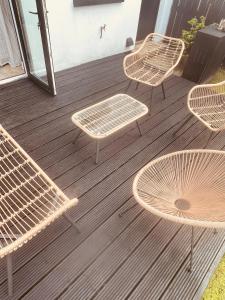 a group of chairs and tables on a deck at The Maiden Studio. Derry city. Studio Apartment. in Derry Londonderry