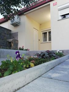 a flower garden in front of a house at Apartma Mi-Mari2 in Koper