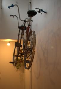 a bike hanging on a wall in a room at florinda casa orgánica in San Salvador de Jujuy
