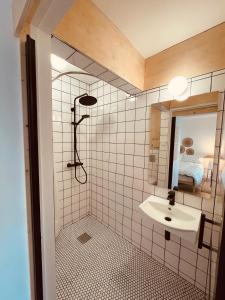 a bathroom with a sink and a shower at The Maiden Studio. Derry city. Studio Apartment. in Derry Londonderry