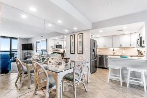 a kitchen and dining room with a table and chairs at Golden Sands 607 in Ocean City
