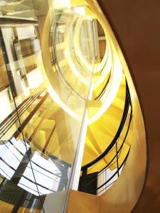 a spiral staircase in a building with a window at Ikonik Hotel Puebla in Puebla