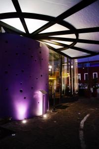 a building with a climbing wall with balls on it at Ikonik Hotel Puebla in Puebla