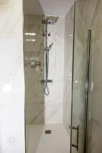 a shower with a glass door in a bathroom at La Tahona in Fermoselle