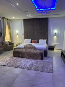 a bedroom with a bed with a blanket on it at The King's Landing Apartments in Maiyegun