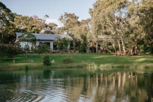 a house next to a lake at Hart's Farm in Shoreham