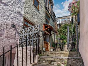 a stone house with a gate and stairs in front at 2 bed in Brixham BX020 in Brixham