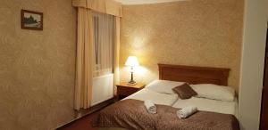 Postel nebo postele na pokoji v ubytování Hotel a restaurace Pomezí
