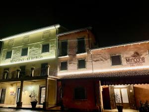a lit up building in a city at night at Mingone Hotel Ristorante in Isola del Liri