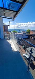 a balcony of a building with a view of the ocean at Mantarraya in Puerto Baquerizo Moreno
