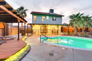 a house with a swimming pool in front of a house at Laughlin Retreat with Pool 2 Mi to Big Bend! in Laughlin