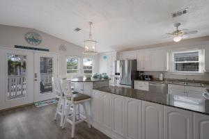 a kitchen with white cabinets and a counter top at Canario Cottage Home in Anna Maria +24 photos