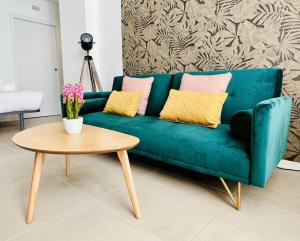 a green couch in a living room with a table at Exclusive LOFT in Ruzafa (SOHO) in Valencia