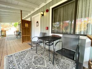 a patio with a table and chairs on a porch at Sierra Mountain Lodge - Vacation Rentals - Yosemite in Ahwahnee