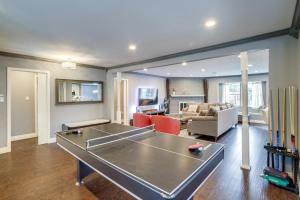 a living room with a ping pong table in it at Updated Houston Home with Backyard and Ping Pong! in Houston